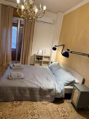 a bedroom with a bed and a chandelier at Casa di Sylwia in Termini Imerese