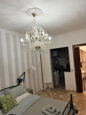 a chandelier in a room with a bed at Casa di Sylwia in Termini Imerese