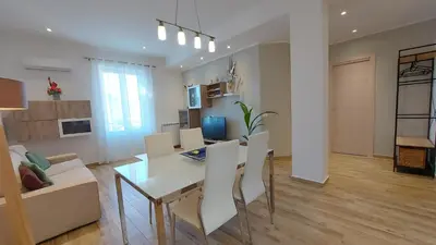 a dining room and living room with a table and chairs at Amedeo Suite - Palermo Centro in Palermo