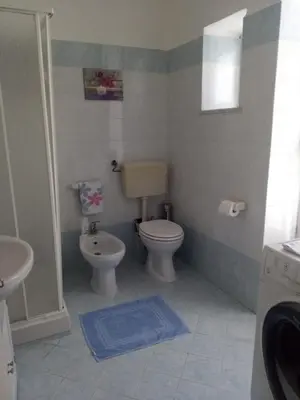 a bathroom with a toilet and a sink at Il balcone sulla Kalsa in Palermo