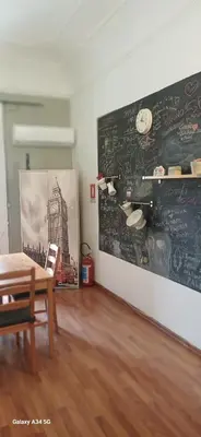 a dining room with a table and a chalkboard on the wall at Il balcone sulla Kalsa in Palermo