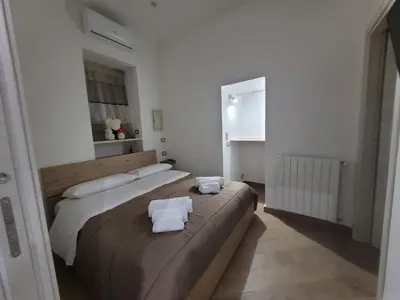 a bedroom with two beds with towels on them at Sweet Home Maqueda in Palermo