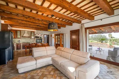 a living room with a couch and a kitchen at Villa DelMarmo in Alcamo