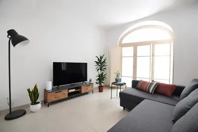 a living room with a couch and a flat screen tv at iFlat Le stanze del Principe in Palermo