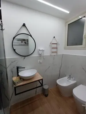 a bedroom with a bed with a white ribbon on it at Yris House in Palermo