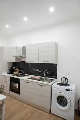 a kitchen with a washing machine and a washer at Yris House in Palermo