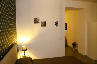 a living room with a couch and a wall with pictures at MARICCHIA per SAITTA HOLIDAYS in Palermo