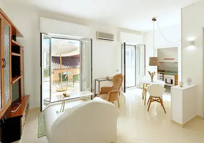 a white living room with a table and chairs at Solemar Sicilia - Terrazza del Merlo in Palermo
