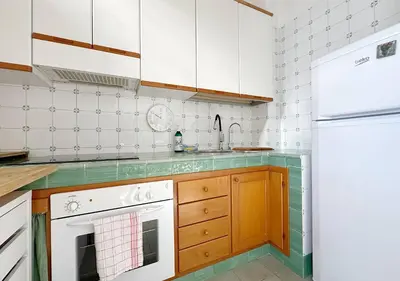 a kitchen with white appliances and a white refrigerator at Solemar Sicilia - Terrazza del Merlo in Palermo