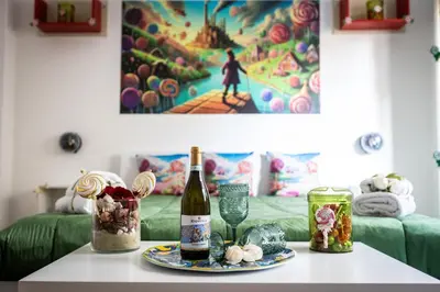 a table with a bottle of wine and a plate of food at Nanà Apartment in Palermo