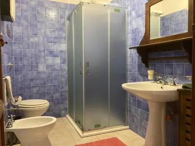 a bathroom with a shower and a toilet and a sink at Noravilla con piscina fra mare e montagne in Mandra Capreria