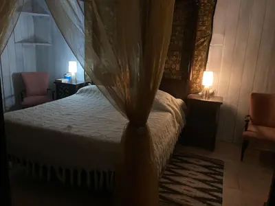 a bedroom with a bed with a mosquito net at Noravilla con piscina fra mare e montagne in Mandra Capreria
