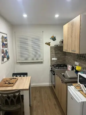 a kitchen with a table and a stove top oven at Lolli House in Palermo