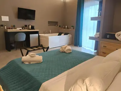 a room with a bed and a mirror with towels at L'Opera - Luxury Apartment in Palermo
