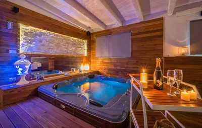 a large bathroom with a jacuzzi tub with candles at Oasi Relax - Romantic Room & Spa in Torretta