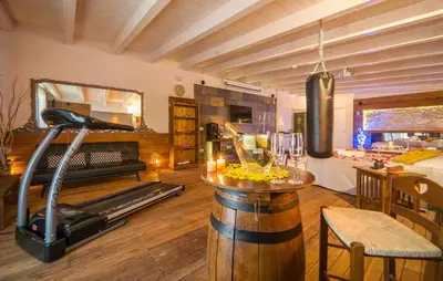 a living room with a gym with a treadmill at Oasi Relax - Romantic Room & Spa in Torretta