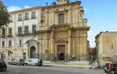 an old stone building with cars parked in front of it at Gorgeous Apartment In Palermo With Wifi in Palermo