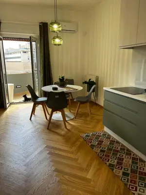 a kitchen and dining room with a table and chairs at politeama view apartment in Palermo
