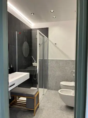 a bathroom with a shower and a sink and a toilet at politeama view apartment in Palermo