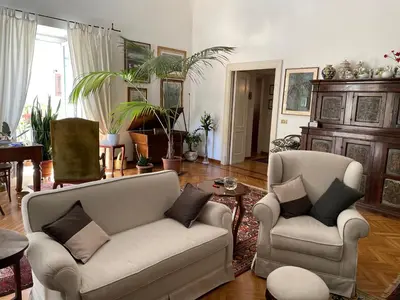 a living room with two chairs and a table at Da Cristina Palazzo Atanasio in Palermo