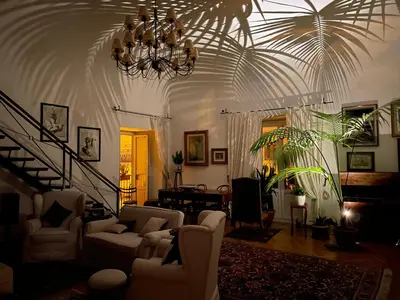 a living room with white furniture and a chandelier at Da Cristina Palazzo Atanasio in Palermo