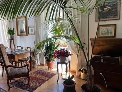 a living room with a table and potted plants at Da Cristina Palazzo Atanasio in Palermo