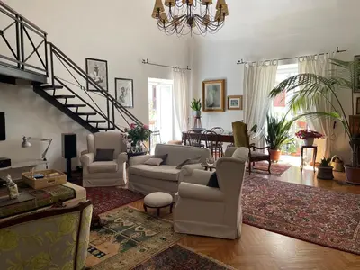 a living room with a couch and chairs and a staircase at Da Cristina Palazzo Atanasio in Palermo