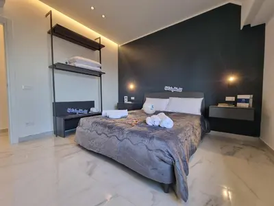 a bedroom with a large bed with two towels on it at MaXelA Penthouse by Holiday World in Palermo