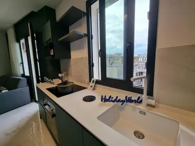 a bathroom with a large sink and a window at MaXelA Penthouse by Holiday World in Palermo