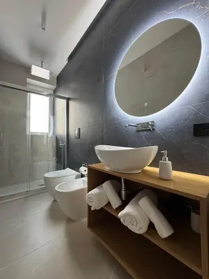 a bathroom with two sinks and a large mirror at Politeama's Home - Luxury Apartment in Palermo