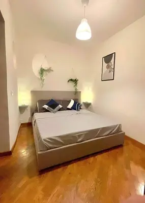 a bedroom with a large bed in a room at Vicolo 20 in Palermo