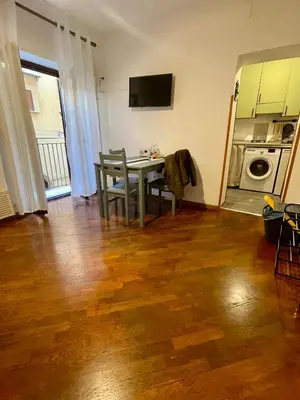 a living room with a table and a microwave at Vicolo 20 in Palermo
