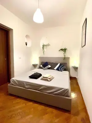 a bedroom with a large bed in a room at Vicolo 20 in Palermo