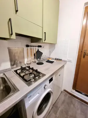 a kitchen with a stove and a washing machine at Vicolo 20 in Palermo