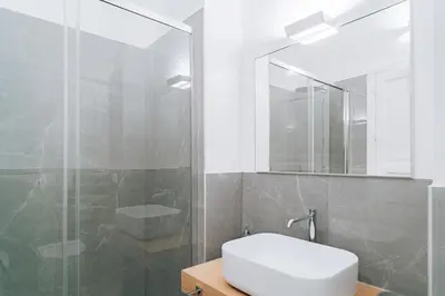 a bathroom with a sink and a shower at Giardino del Foro in Palermo