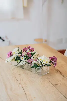 a bouquet of flowers sitting on a wooden table at Giardino della Kalsa in Palermo