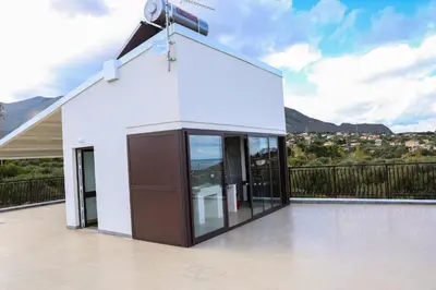 a white building with a camera on a balcony at Trabia Casa Bianca A in Mandra Capreria