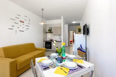 a living room with a table and a couch at Casa Vacanze Margherita in San Vito lo Capo
