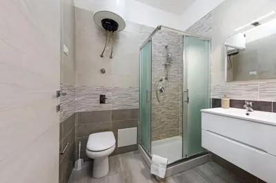 a bathroom with a shower and a toilet and a sink at Casa Vacanze Margherita in San Vito lo Capo