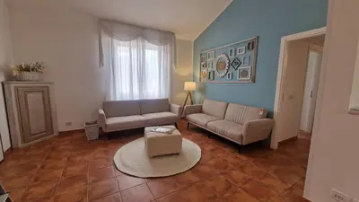 a living room with two couches and a table at Casa Corte Fiorita in San Vito lo Capo