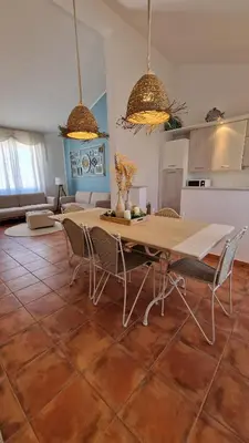 a kitchen and dining room with a table and chairs at Casa Corte Fiorita in San Vito lo Capo