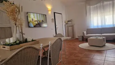 a living room with a couch and a table at Casa Corte Fiorita in San Vito lo Capo