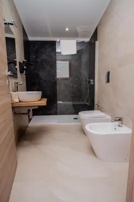 a bathroom with a sink and a toilet and a shower at Porta Nuova Suite & Rooms city center in Palermo