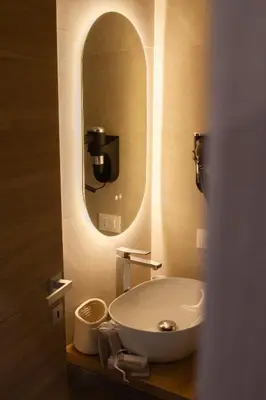 a bathroom with a sink and a mirror at Porta Nuova Suite & Rooms city center in Palermo