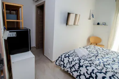 a small bedroom with a bed and a television at Porta Nuova Suite & Rooms city center in Palermo