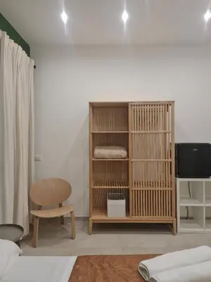 a room with a bed and a chair and a tv at Porta Nuova Suite & Rooms city center in Palermo