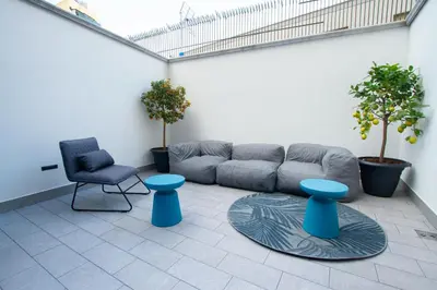 a living room with a couch and a chair at Porta Nuova Suite & Rooms city center in Palermo