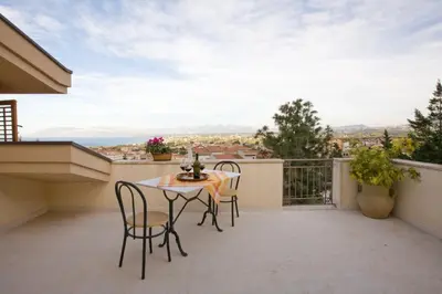 a patio with a table and chairs on a balcony at Villa Rizzo in Castellammare del Golfo