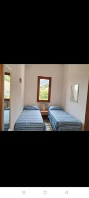 two beds in a room with a window at Villa Rizzo in Castellammare del Golfo