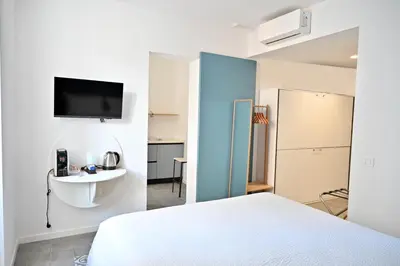 a bedroom with a bed and a tv on a wall at Aria di Sale centro storico in Palermo